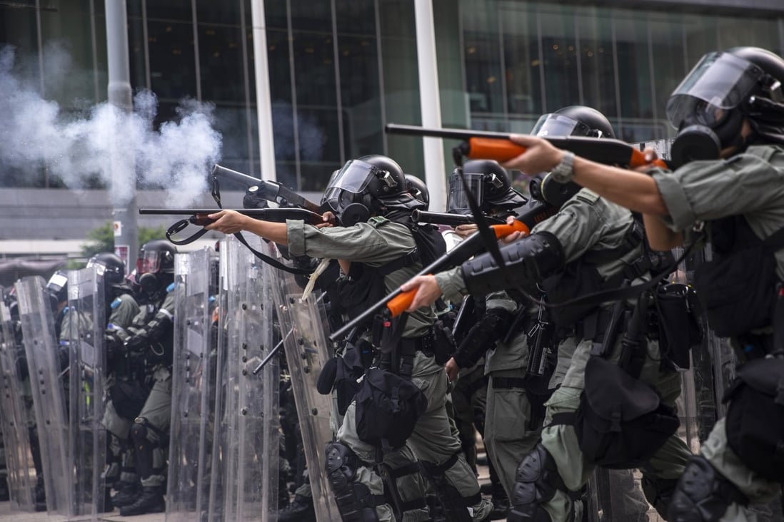 Riot police fire non-lethal rounds to disperse protesters in the Admiralty district of Hong Kong on Sunday. The violence escalated on Tuesday when an officer shot a protester at close range in the chest with a live round. Photo: Bloomberg