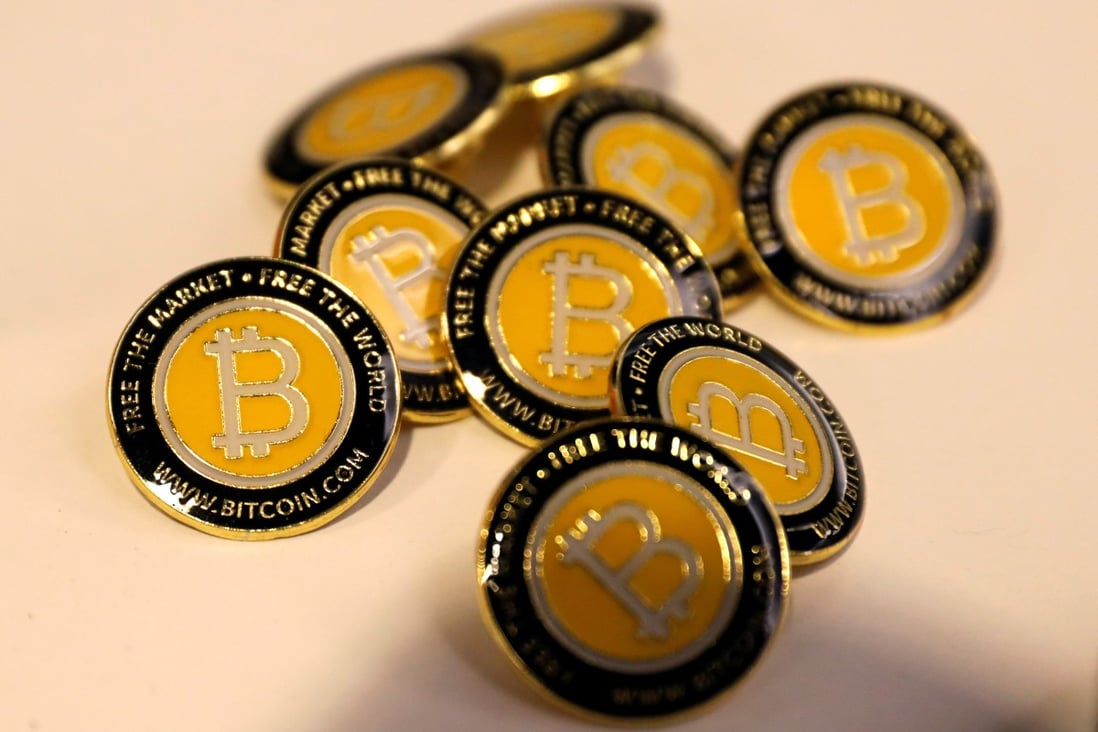 Bitcoin.com buttons are seen displayed on the floor of the Consensus blockchain technology conference in New York, in May 2018. Photo: Reuters