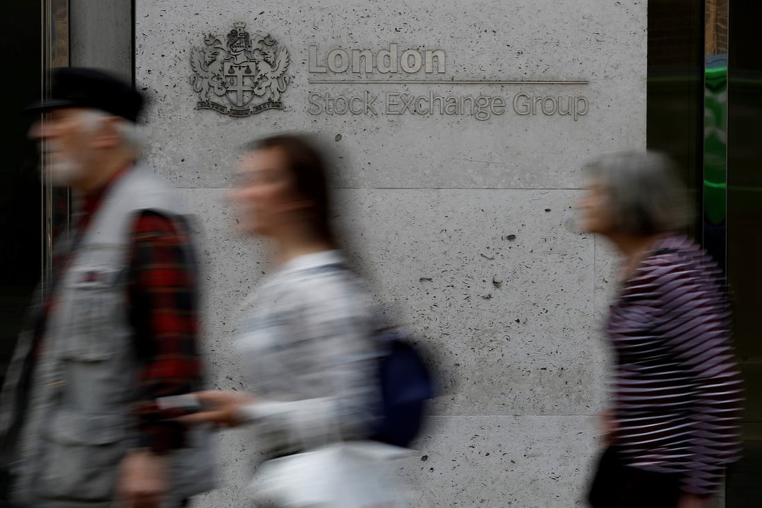 People walk past the entrance of the London Stock Exchange. Photo: Reuters