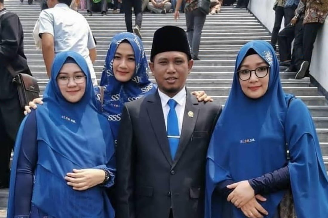 Achmad Fadil Muzakki Syah, 39, and his three wives. Photo: Twitter