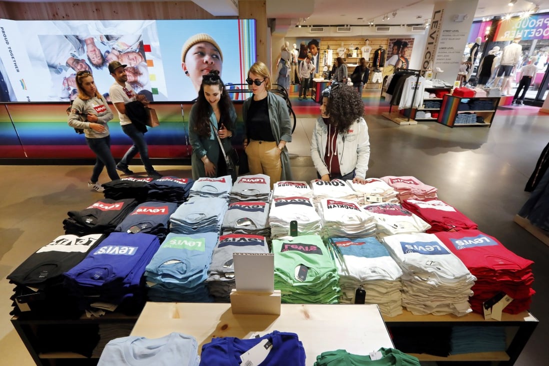 Shoppers at a Levi’s store in New York’s Times Square look at a T-shirt display in June. The domestic consumer is critical to the health of America’s economy, as consumer spending accounts for roughly 70 per cent of US economic activity. Photo: AP