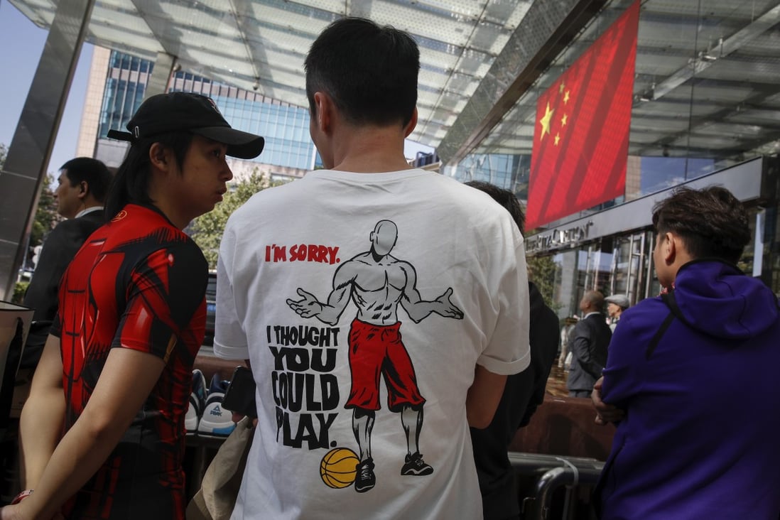 Chinese fans wear NBA T-shirts as they wait outside the Ritz-Carlton hotel to catch a glimpse of NBA players. Photo: AP