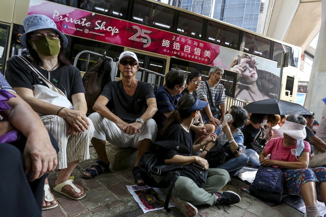Dozens of elderly Hongkongers risk arrest for illegal assembly on Saturday by staging a sit-in outside Wan Chai police headquarters. Photo: Jonathan Wong