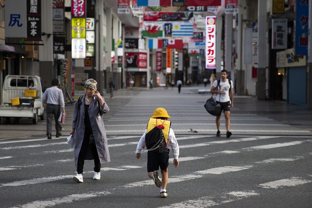 A Japanese boy crosses a road on his way to school. Photo: AP