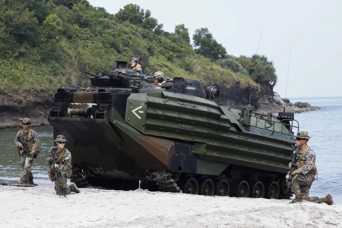 US Marines take security positions around an amphibious assault vehicle during a joint military amphibious landing exercise with Philippine and Japanese counterparts in Cavite province, Philippines. Photo: EPA-EFE