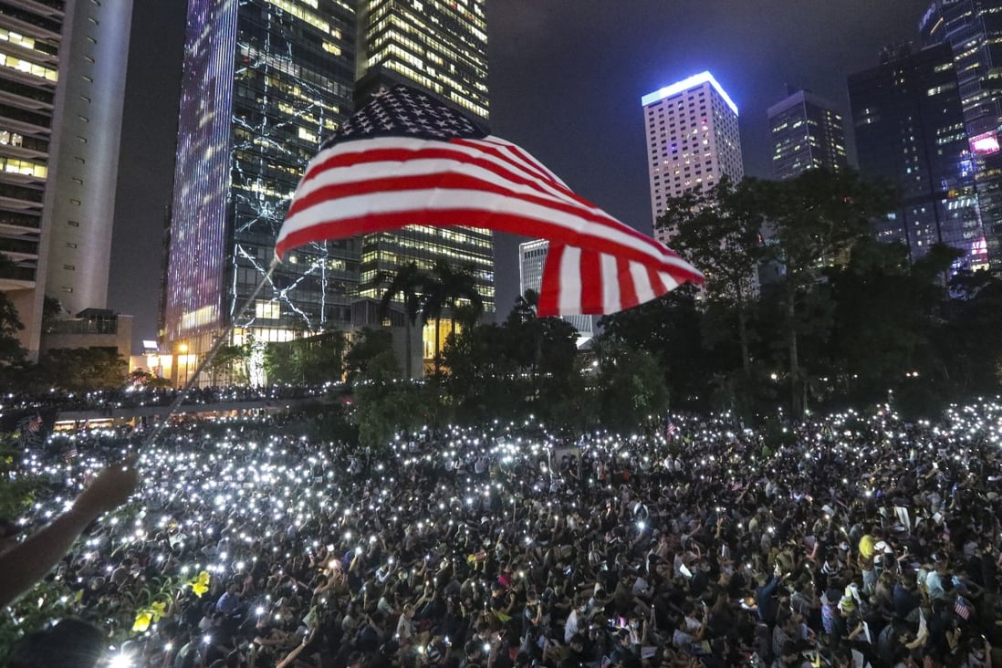Anti-government protesters wave the US flag during a protest at Chater Garden in Central. Photo: Felix Wong