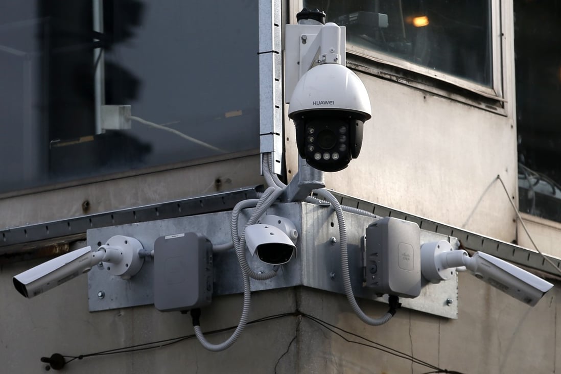 Video cameras hang from an office building in downtown Belgrade, Serbia. Photo: AP