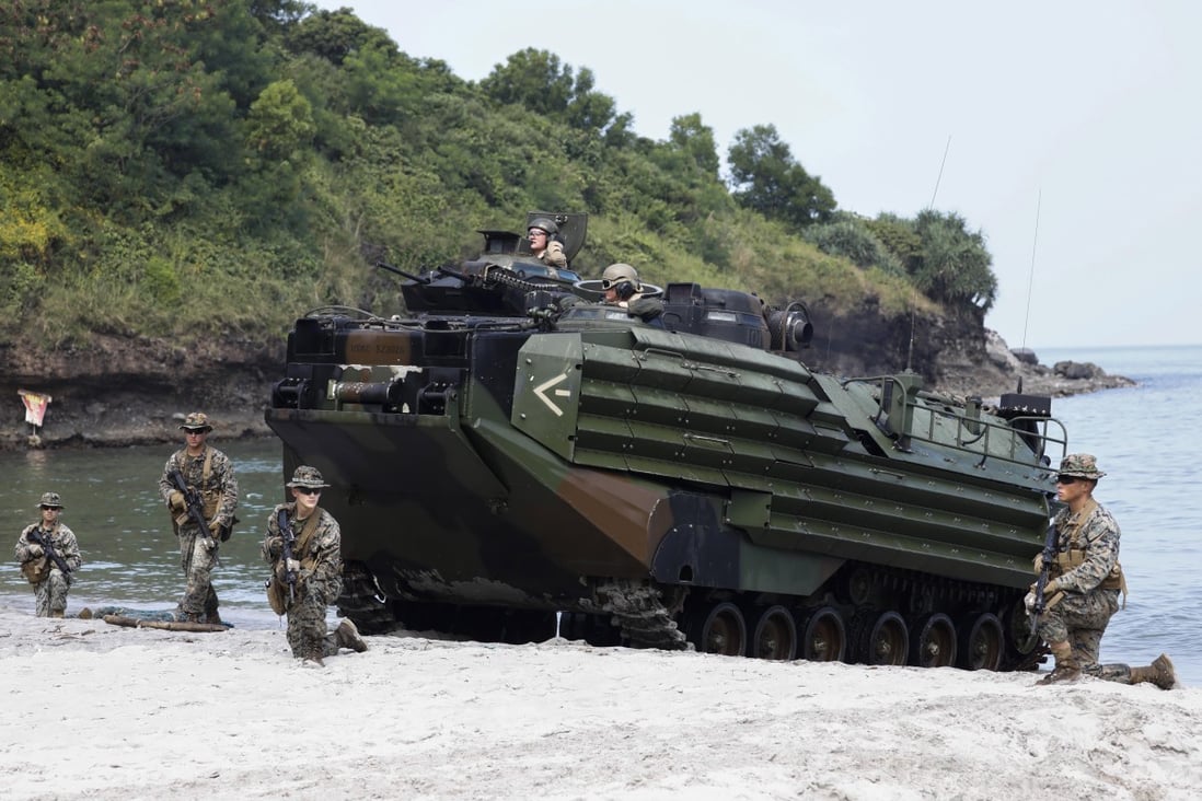 US Marines take security positions around an amphibious assault vehicle during a joint military exercise with the Philippines and Japan near Manila on October 12. Photo: EPA-EFE
