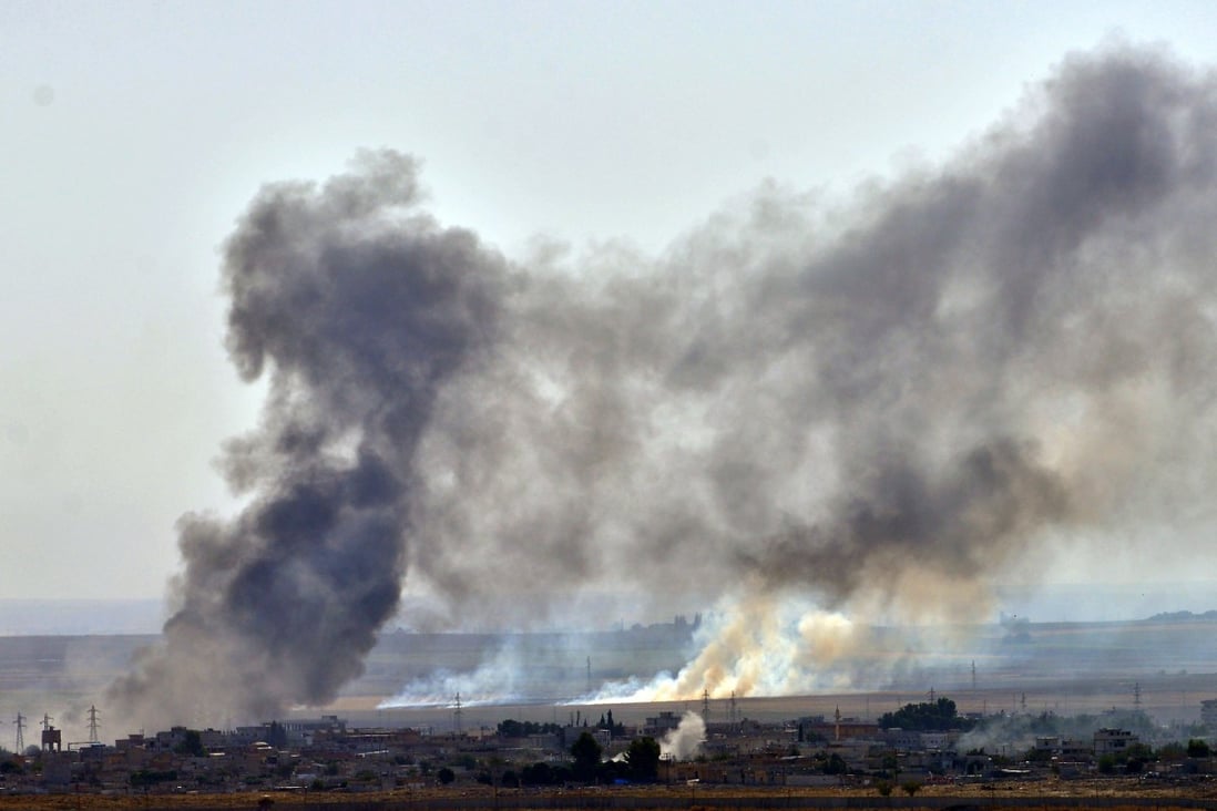 Smoke rises from the northern Syrian city of Ras al-Ain during an attack launched by the Turkish army on Sunday. Isis jihadists held captive in the area have fled. Photo: Xinhua