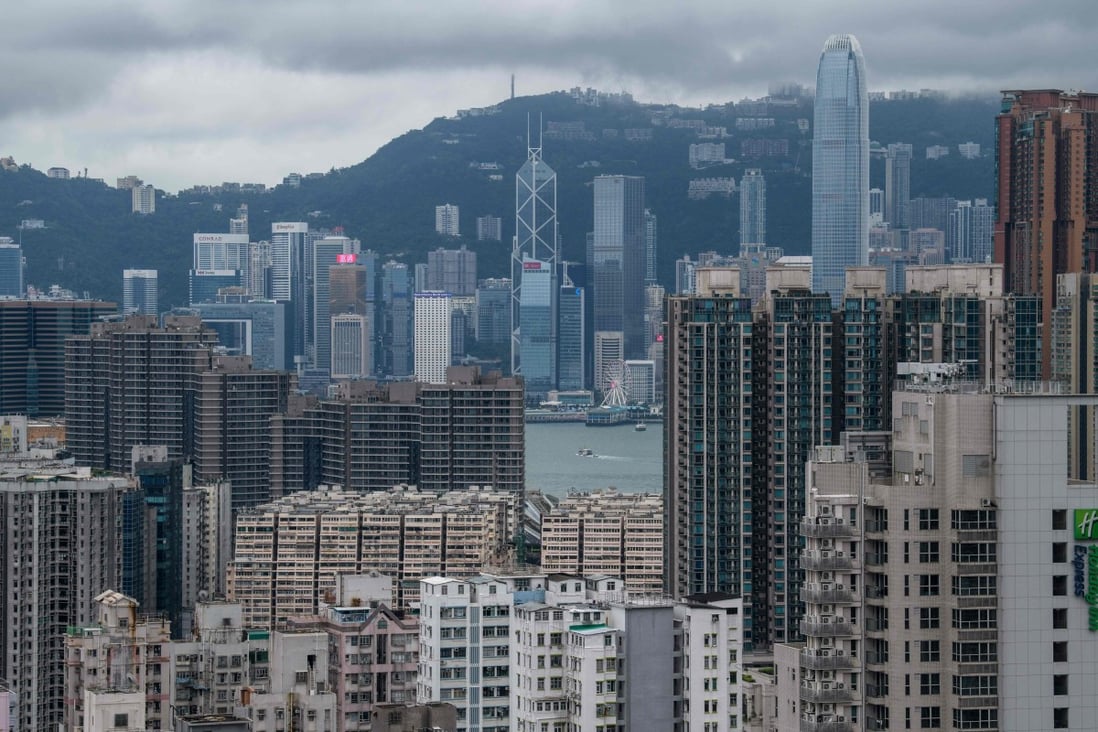 A general view of residential and commercial buildings in the Kowloon district (foreground) with the skyline of Hong Kong Island past Victoria Harbour (C) in the distance on August 3, 2019. Photo: AFP
