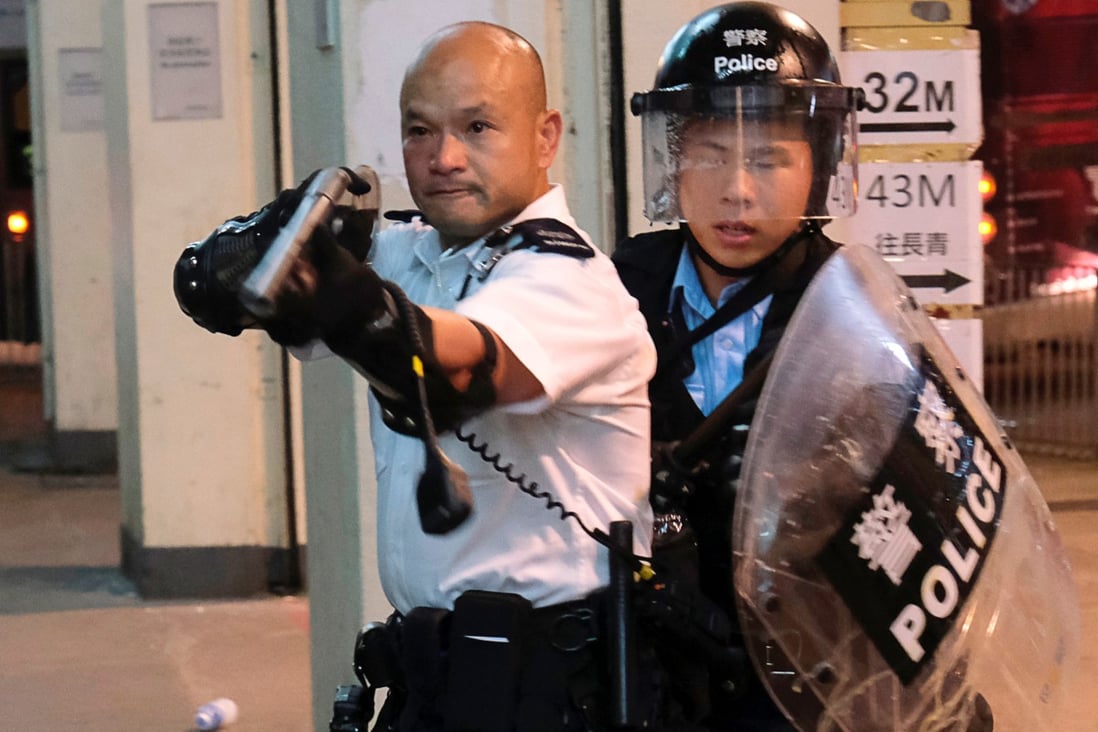 Sergeant Lau Chak-kei became a celebrated figure in mainland China after he raised a shotgun at Hong Kong’s anti-government protesters at Kwai Chung in July. Photo: Reuters