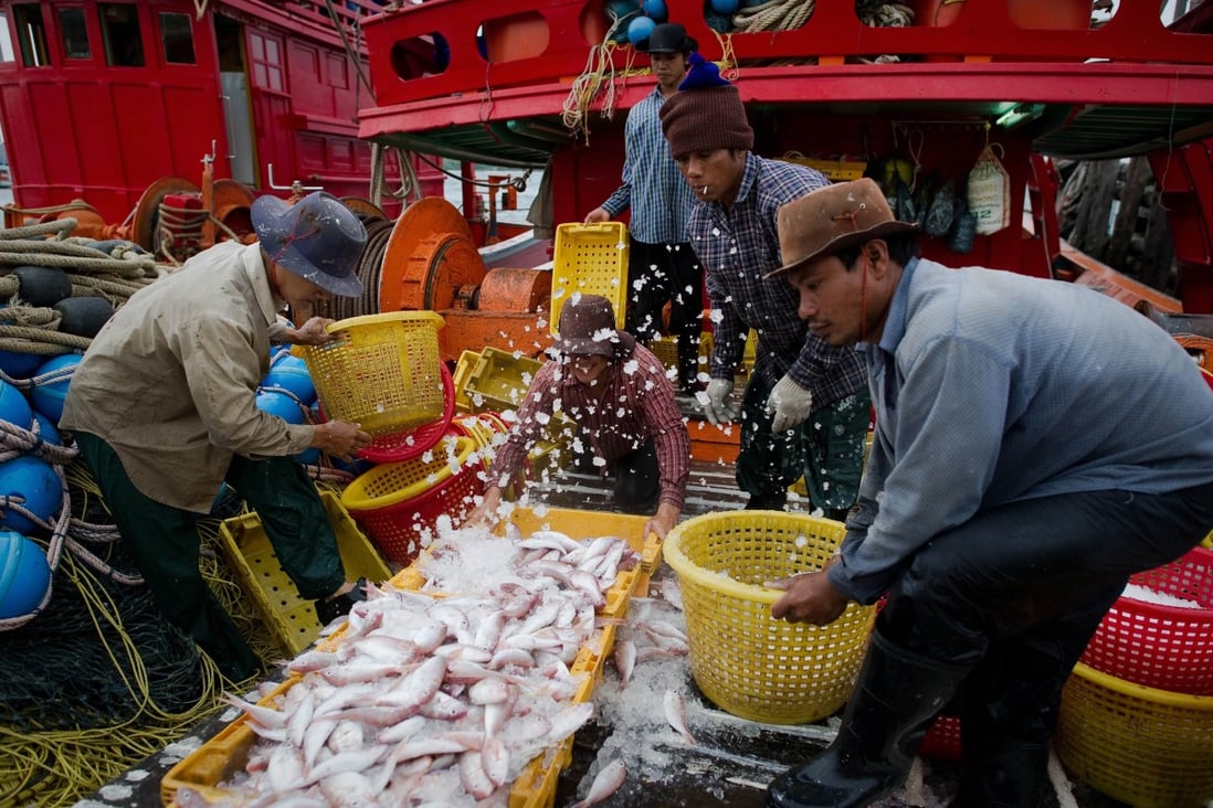 Migrant workers sort fish on a Thai fishing boat. File photo: AFP