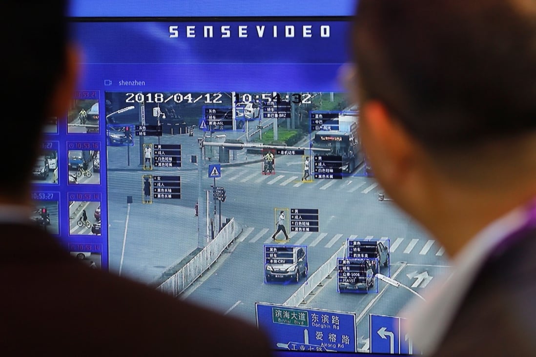 Visitors look at a display demonstrating traffic surveillance at the SenseTime booth at the Security China 2018 exhibition in Beijing, China October 23, 2018. Photo: Reuters