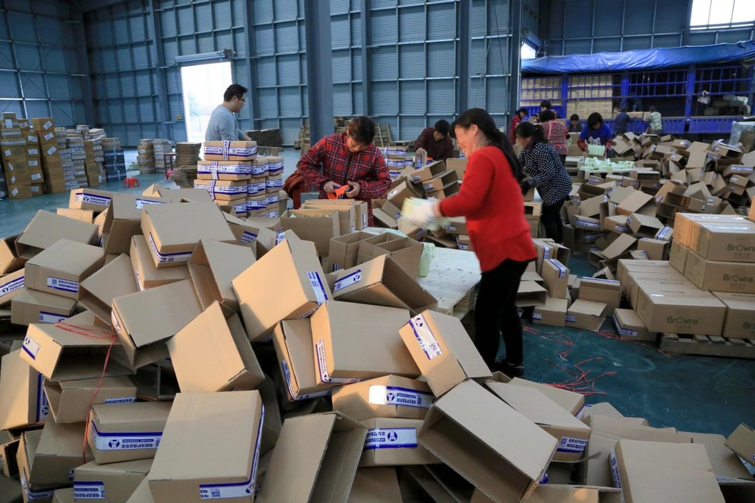Workers wrapping packages at a logistics centre in Lianyungang, east China's Jiangsu province on November 8, 2016. Photo: AFP
