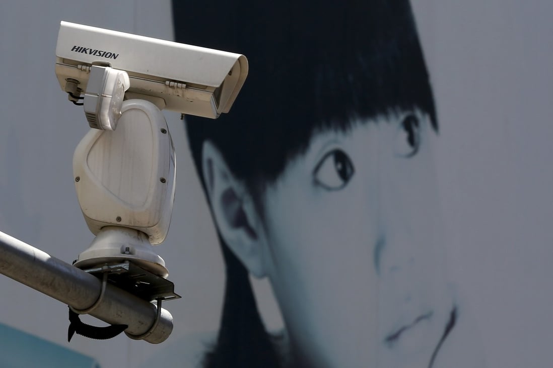A video surveillance camera made by China's Hikvision is mounted on top of a street near a advertisement poster in Beijing, Thursday, May 23, 2019. Photo: AP