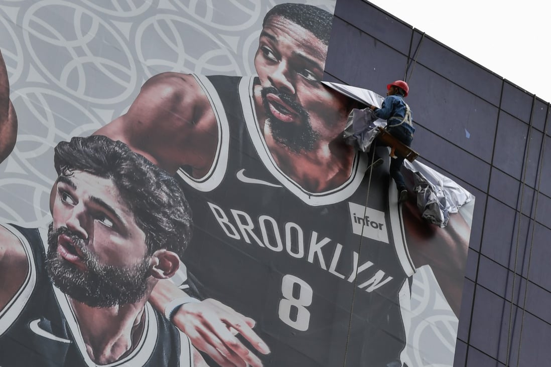 The National Basketball Association’s (NBA) China marketing plan was upended after the Houston Rockets’ general manager tweeted a message supporting Hong Kong protesters. Pictured is an NBA promotional banner being removed in Shanghai on October 9. Photo: AFP