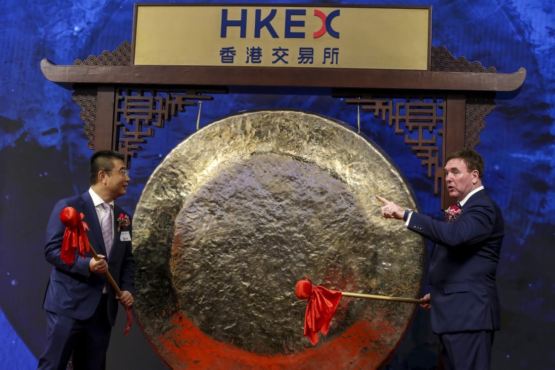 ESR Cayman’s co-founder and chief executive Jeffrey Shen Jinchu (left) and co-chief executive Stuart Gibson (right) striking the ceremonial gong that marks the trading debut of the company’s shares on the Hong Kong stock exchange on November 1. Photo: Jonathan Wong
