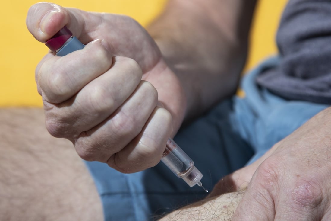 Type 1 diabetes sufferer Simon O’Reilly injecting insulin into his leg, something he does four times a day. Photo: Antony Dickson