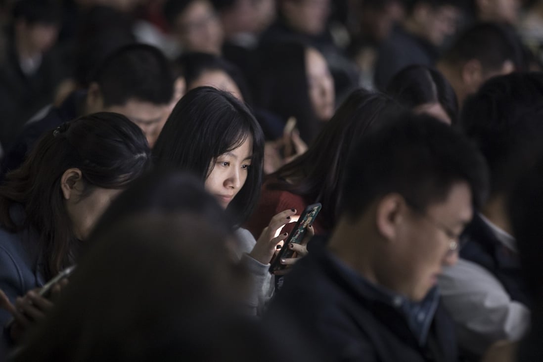 An attendee uses her smartphone during Tencent Holdings' WeChat Open Class Pro conference in Guangzhou last year. For the fourth straight year, the internet in China was ranked the least free among surveyed nations, Freedom House says. Photo: Bloomberg