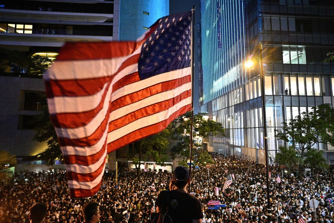 A man waves a US flag as protesters attend a rally in Central, Hong Kong, on October 14, calling on US politicians to pass a bill that could alter Washington’s relationship with the trading hub. Photo: AFP