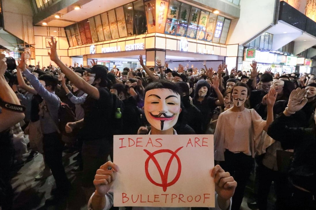 Anti-government protesters with Guy Fawkes masks in Tsim Sha Tsui on Tuesday. Photo: Felix Wong