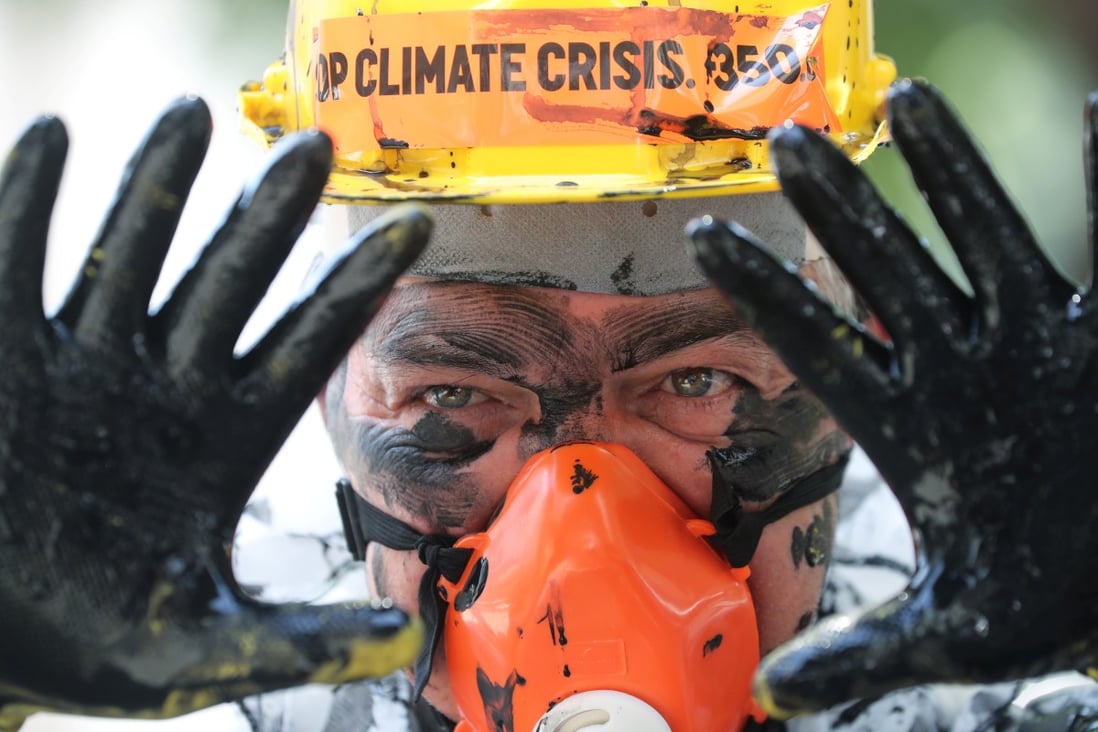 An environmental activist in Rio de Janeiro protests against plans to auction off oil blocks near the coast of Brazil on Tuesday. Photo: Reuters
