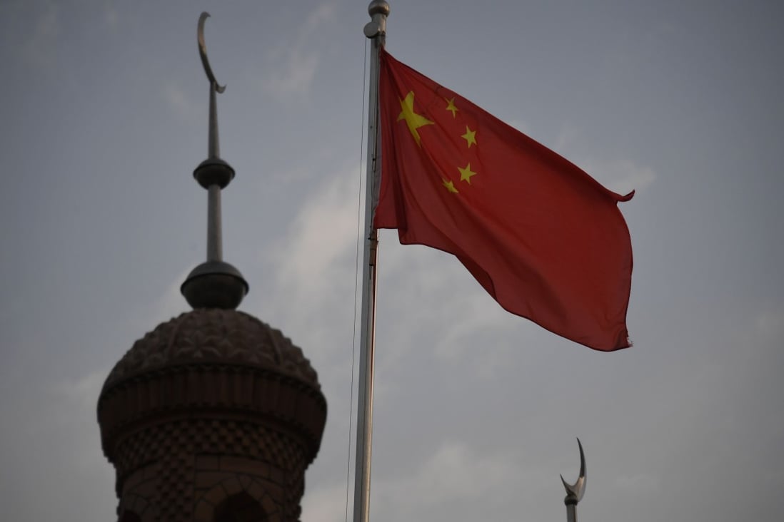 A Chinese flag flies over a mosque in Kashgar, Xinjiang. Photo: AFP