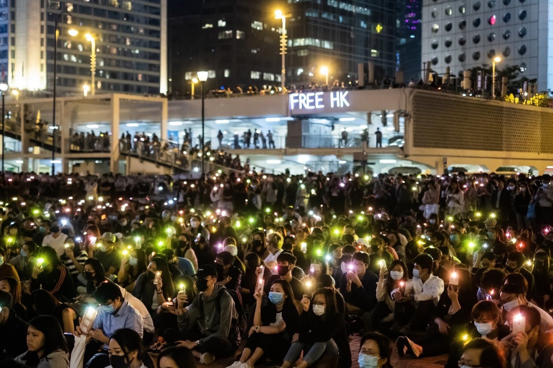 Demonstrators shine lights from their cellphones during a rally at Edinburgh Place in the Central district of Hong Kong on Thursday. Photo: Bloomberg