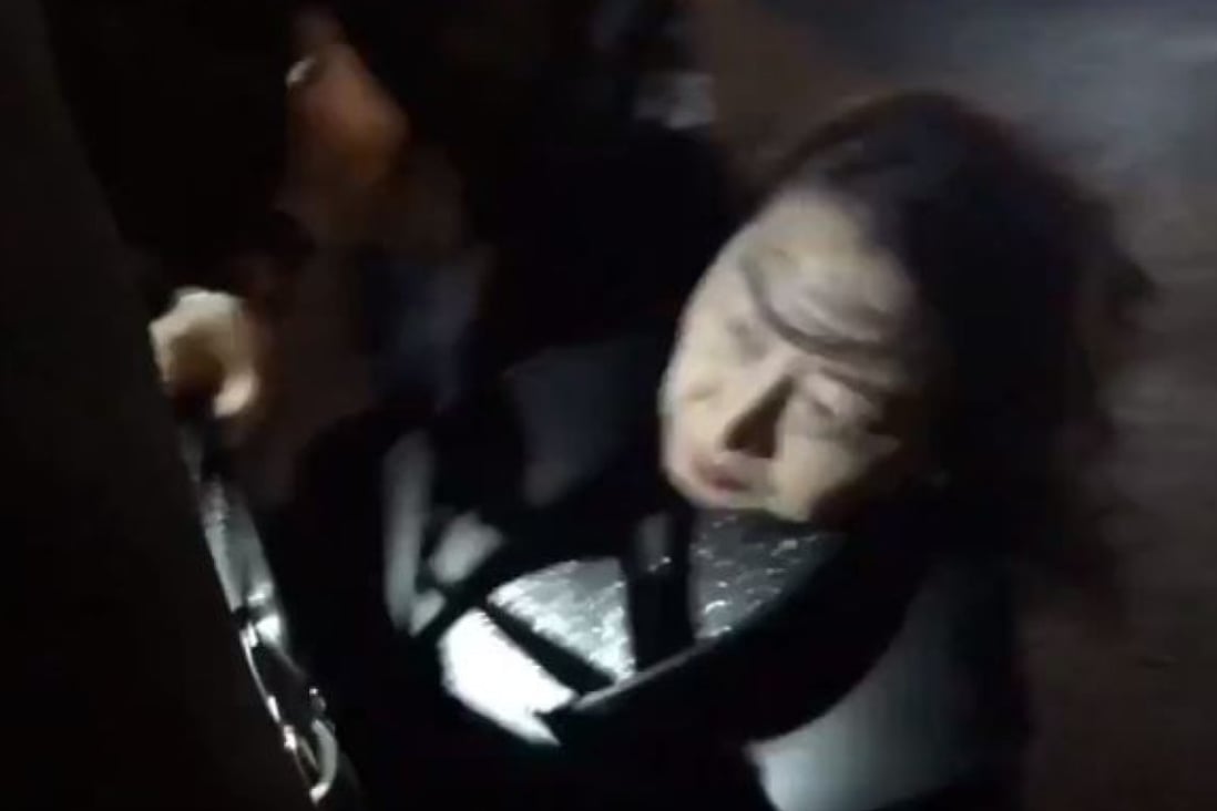Teresa Cheng, Hong Kong’s justice minister, falls in London on Thursday while surrounded by anti-Hong Kong government protesters. Image: Twitter
