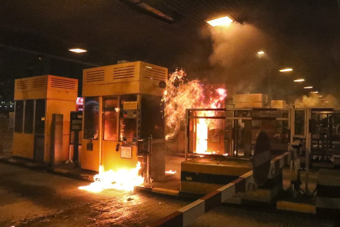 Protesters set tollbooths at the Cross-Harbour Tunnel on fire. Photo: Felix Wong