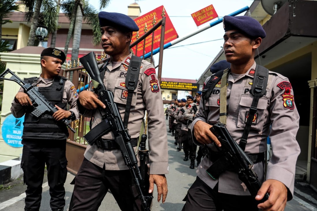 Police officers stand guard at the scene of the suicide bombing at Medan city police headquarters. Photo: EPA