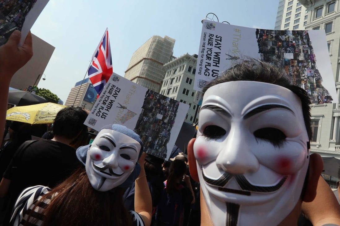 Anti-government protesters wearing Guy Fawkes masks along Salisbury Road in Tsim Sha Tsui, Hong Kong. Photo: Felix Wong