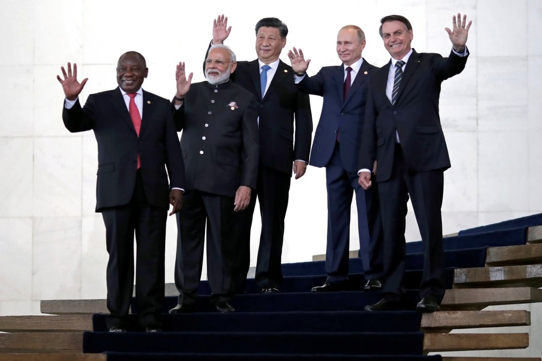 President of South Africa Cyril Ramaphosa, India’s Prime Minister Narendra Modi, President Xi Jinping of China, Russia’s President Vladimir Putin and President Jair Bolsonaro of Brazil pose for a family photo as they arrive for the BRICS summit. Photo: Reuters