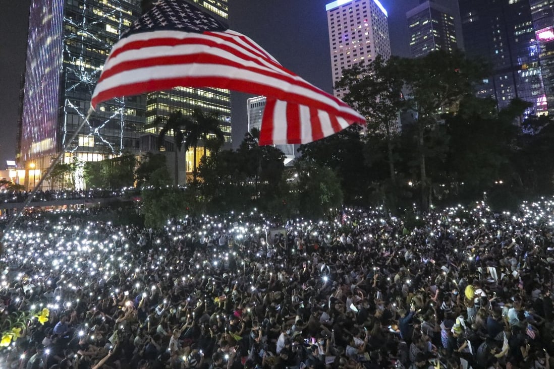 Anti-government protesters wave a US flag during a demonstration at Chater Garden in Central. Photo: Felix Wong