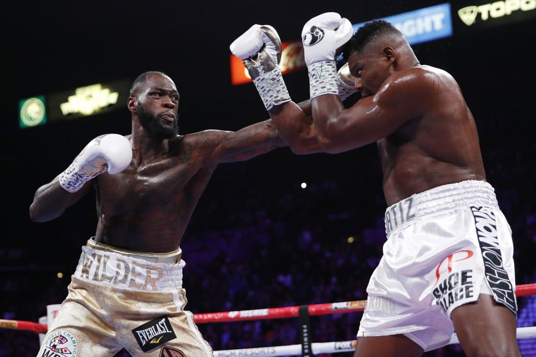 Deontay Wilder throws a left hand against Luis Ortiz in their heavyweight title match. Photo: AP
