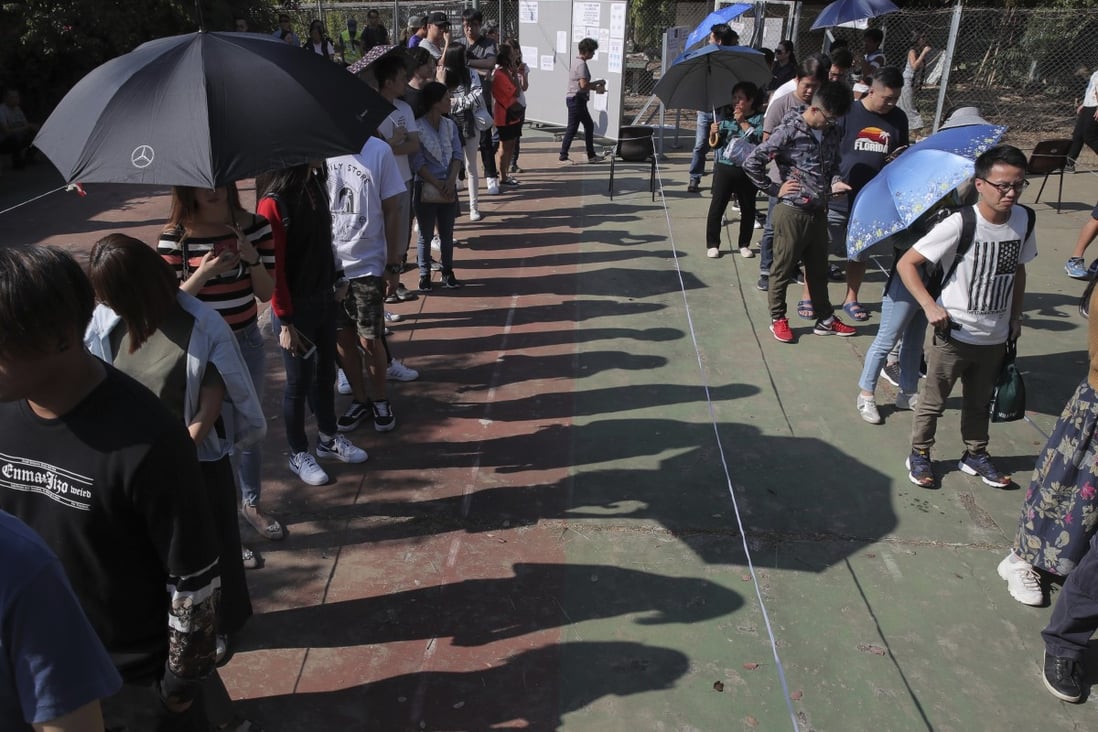 Hongkongers queue up to vote outside a polling station on Sunday. Photo: AP