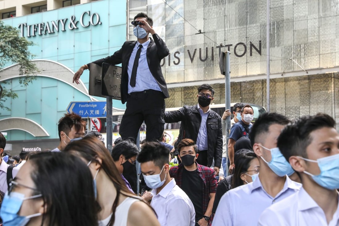 Masked anti-government protesters hold a lunchtime rally in Central. Photo: K.Y. Cheng