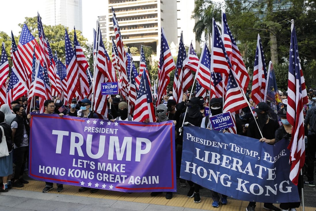 Rallyists wave American flags as they march to US Consulate to thank President Donald Trump. Photo: AP