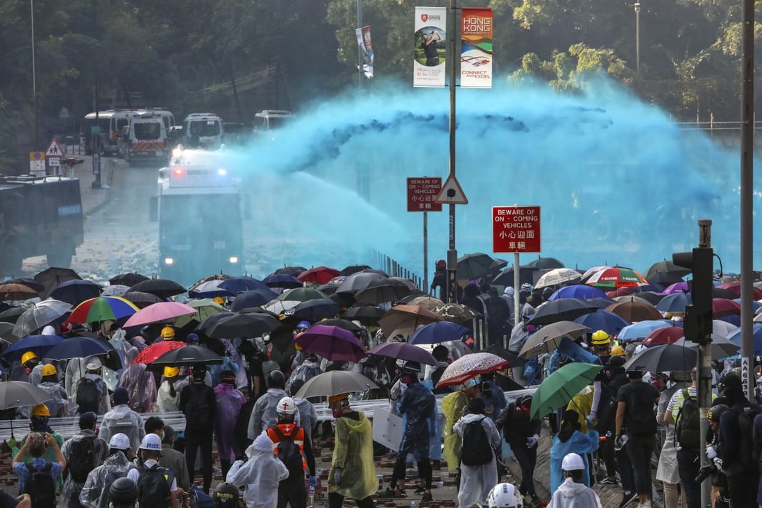 Two water cannon trucks and an armoured vehicle arrive as clashes break out between riot police and students protesting near the Hong Kong Polytechnic University, with tear gas and petrol bombs exchanged, in Hung Hom on November 17. Photo: Felix Wong