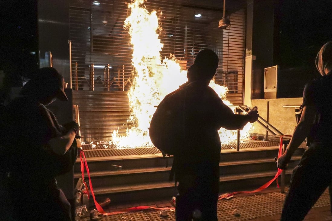 Anti-government protesters set the entrance of Whampoa MTR station on fire, on Sunday. Photo: Edmond So