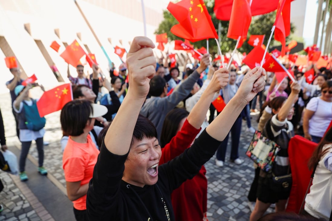 Pro-Beijing supporters sing and wave Chinese flags at a rally underneath the Tsim Sha Tsui clock tower in Hong Kong on December 1. Photo: Reuters