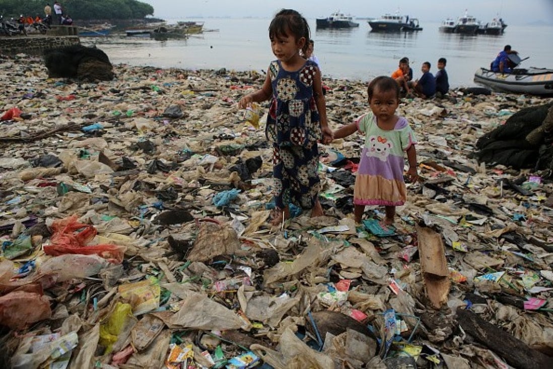 Children on a heavily polluted beach in Bali, Indonesia. A team of Hong Kong students has invented a cheap robot that can collect plastic from the sea and reduced the scourge of marine pollution. Photo: Riau Images/Barcroft Images via Getty Images