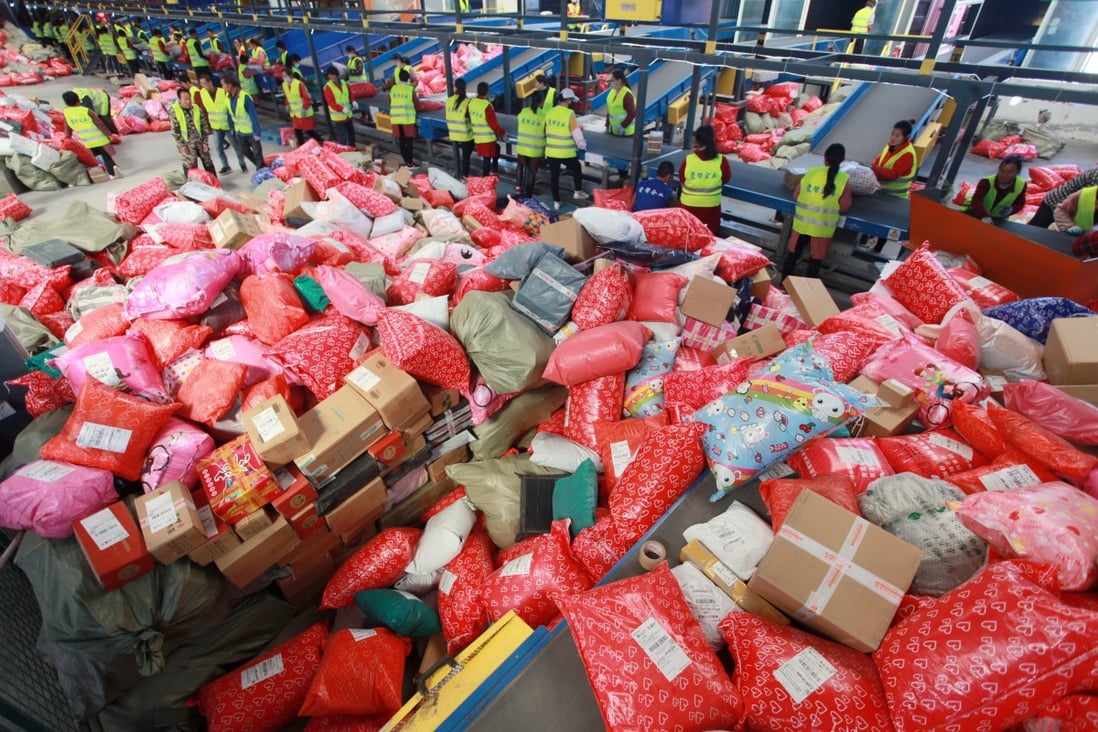 Workers sort packages at a mail processing center on Singles' Day 2019 in Yangzhou City, China. Photo: EPA-EFE