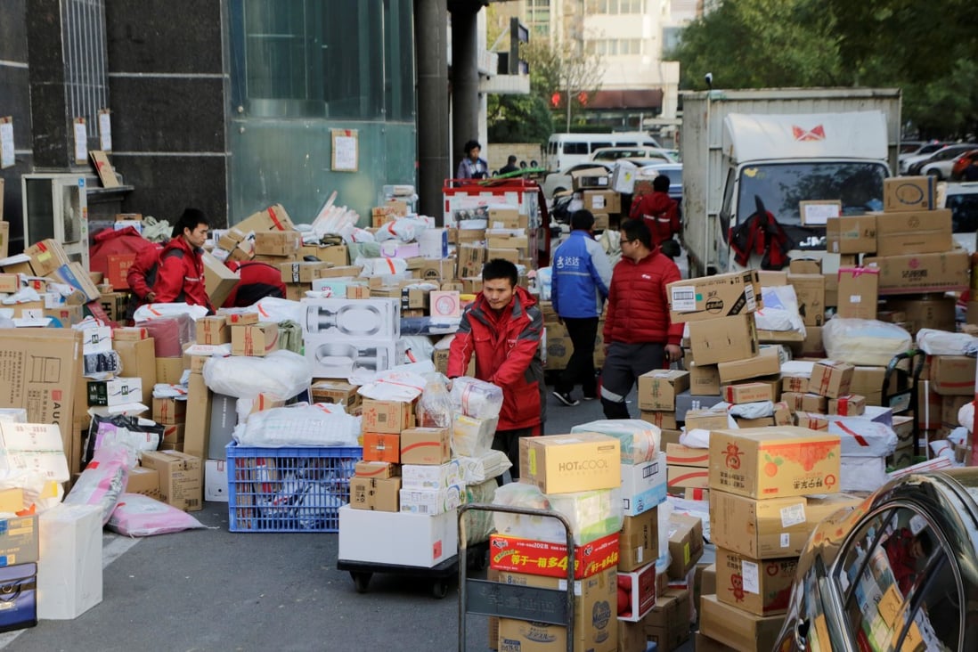 Deliverymen work among parcels beside a road in Beijing on November 12, following the Singles’ Day shopping blitz. China’s labour market has stayed resilient, despite external shocks to the economy. Photo: Reuters