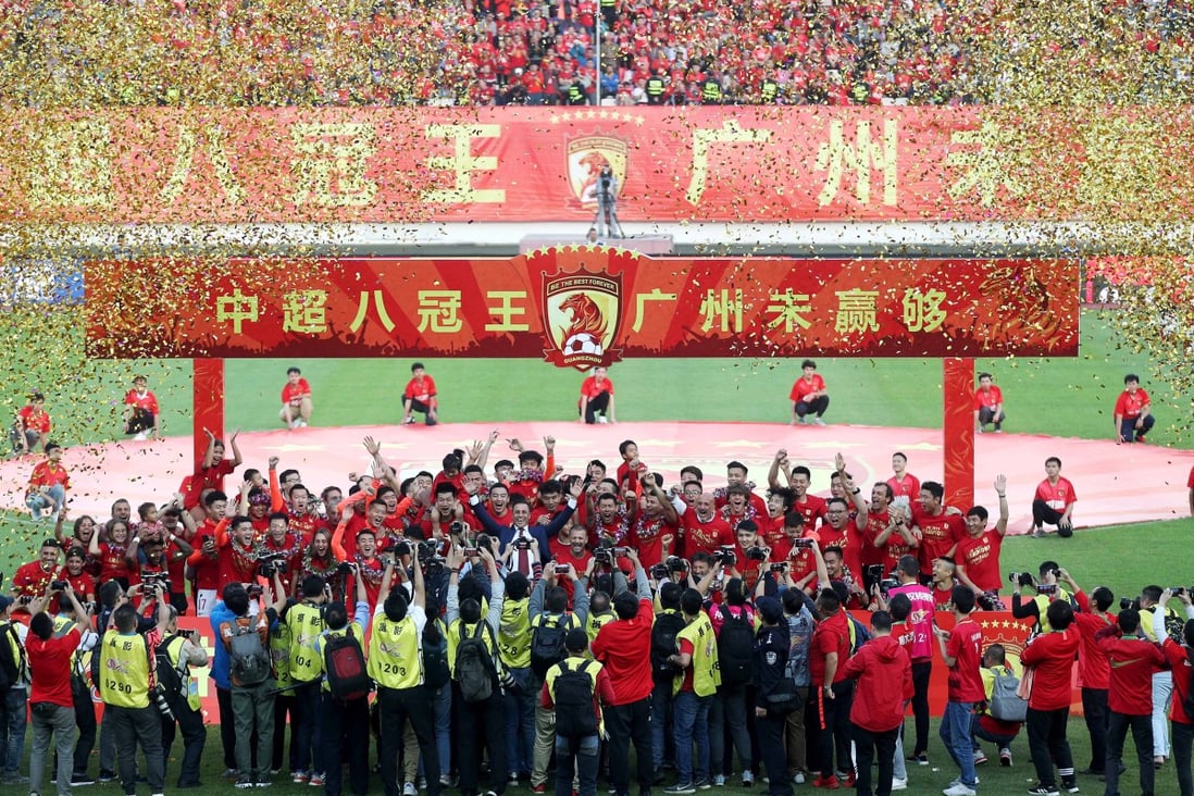 Guangzhou Evergrande players and staff celebrate after winning a record eighth Chinese Super League title. Photo: Xinhua