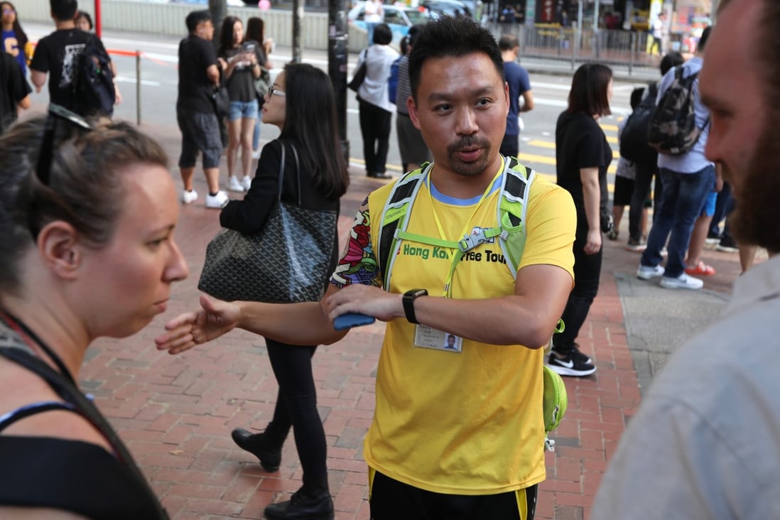 Protest Tour guide Michael Tsang Chi-fai (centre) takes tourists Sarah Severance (L) from US and Andrew Jones (R) from UK, around the protest areas, Tin Hau. 02NOV19 SCMP / Xiaomei Chen
