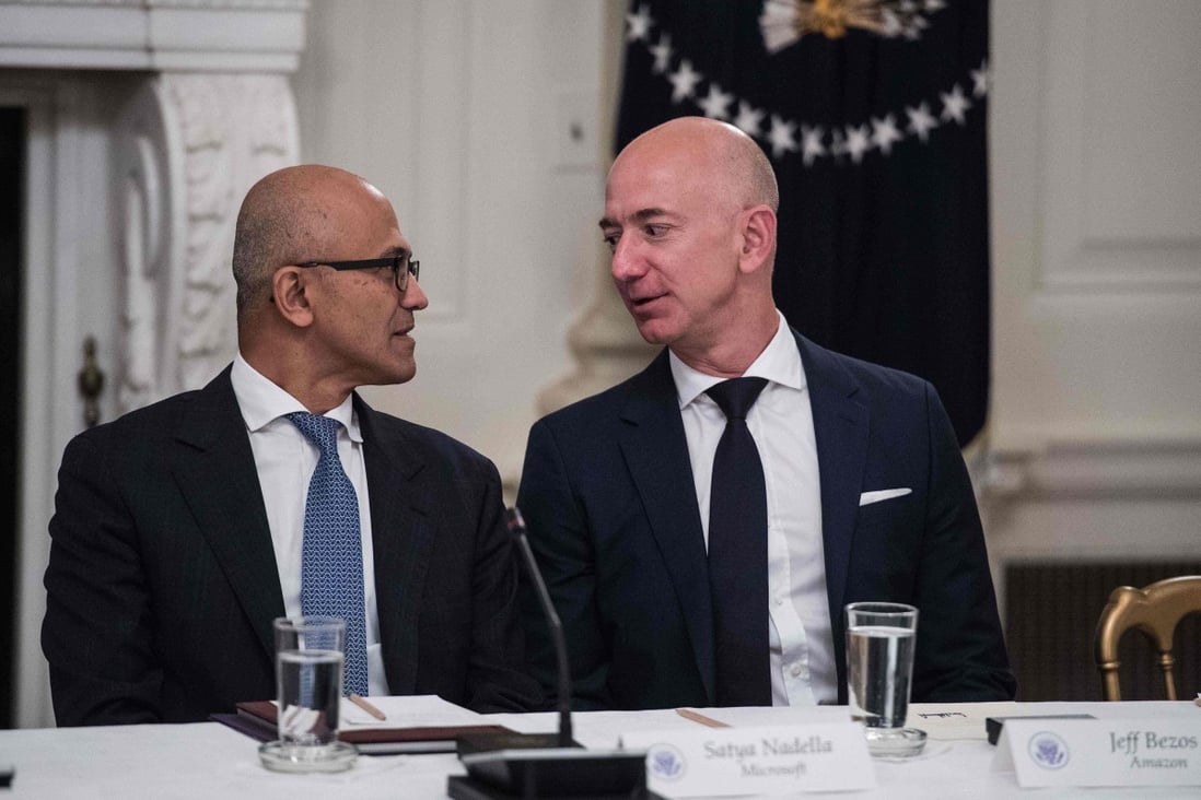 Microsoft CEO Satya Nadella (L) and Amazon CEO Jeff Bezos chat during an American Technology Council roundtable at the White House in Washington, DC, on June 19, 2017. Photo: AFP