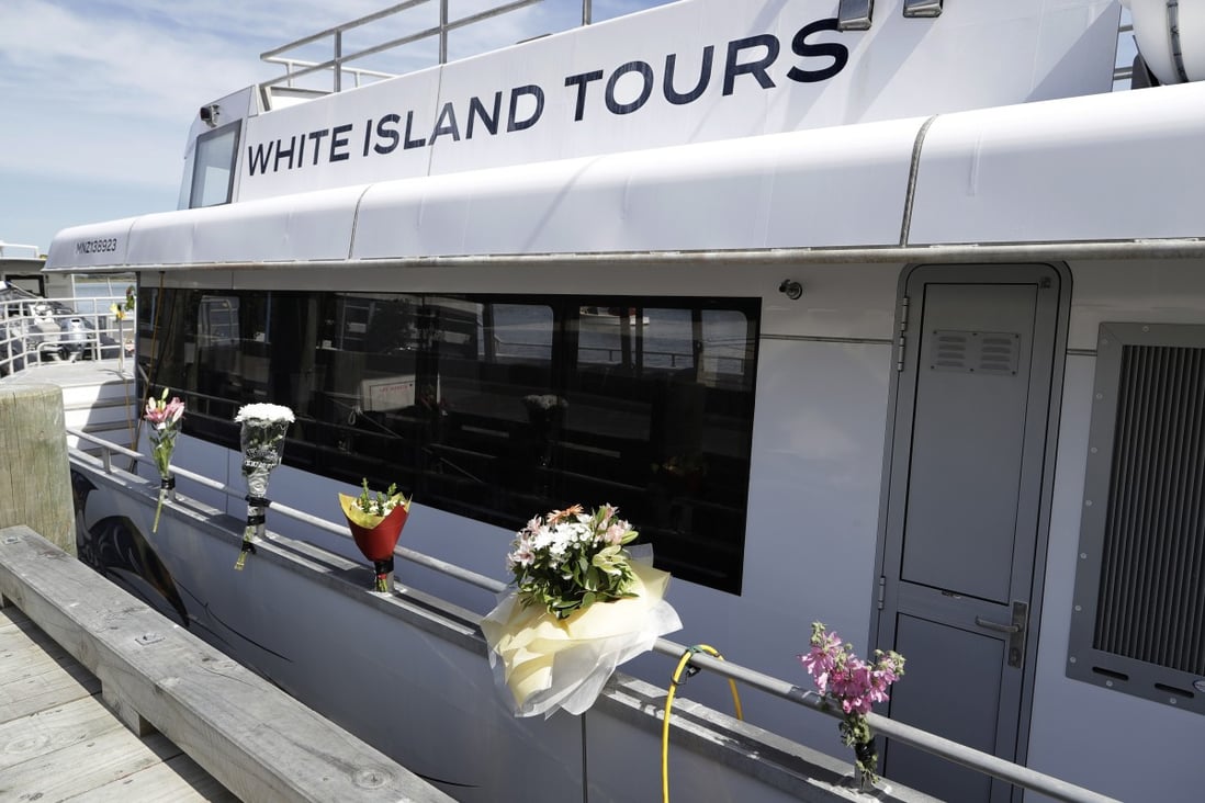 Bouquets of flowers sit on one of the two tour boats that went to White Island. Photo: AP