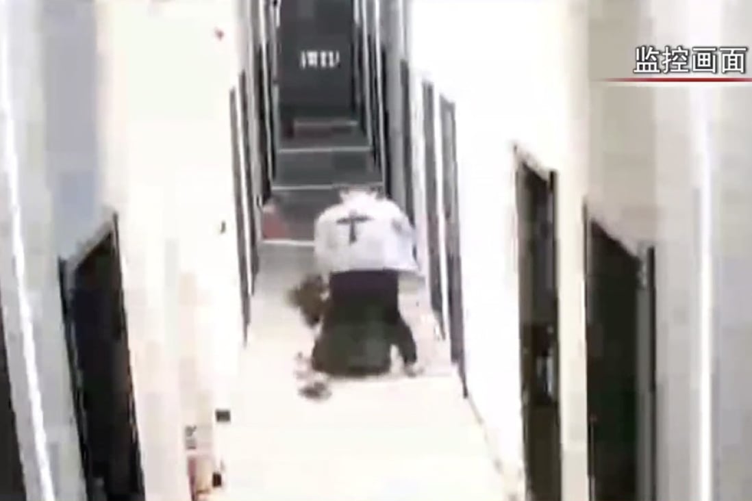 A police officer from Shenzhen has been detained after a video showed a man dragging a woman from a flat and punching her to the ground. Photo: Weixin