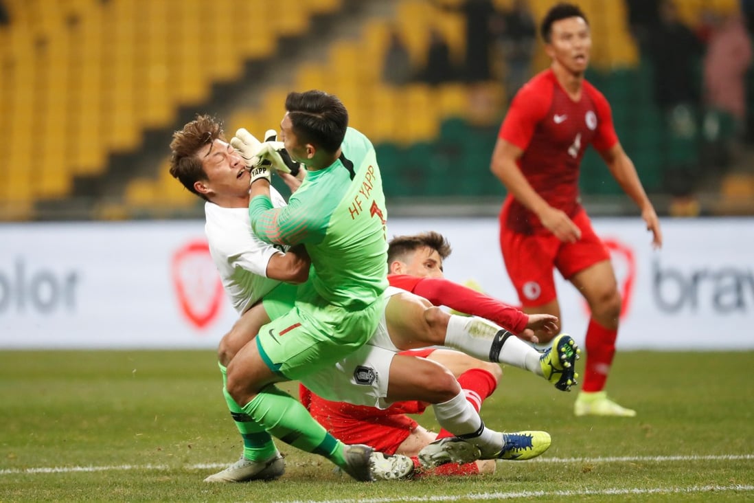 Hong Kong goalkeeper Yapp Hung-fai gets in a tangle with a South Korea player during their match at the EAFF Championship in Busan. Photo: Reuters